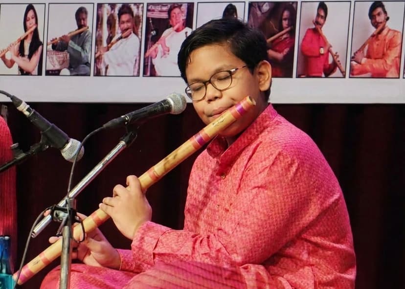 A younger Aditya performing Indian classical flute